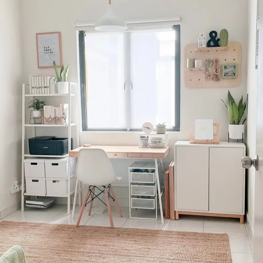 A bright home office featuring white furniture and ample natural light, a simple small apartment decorating idea for creating an open feel.